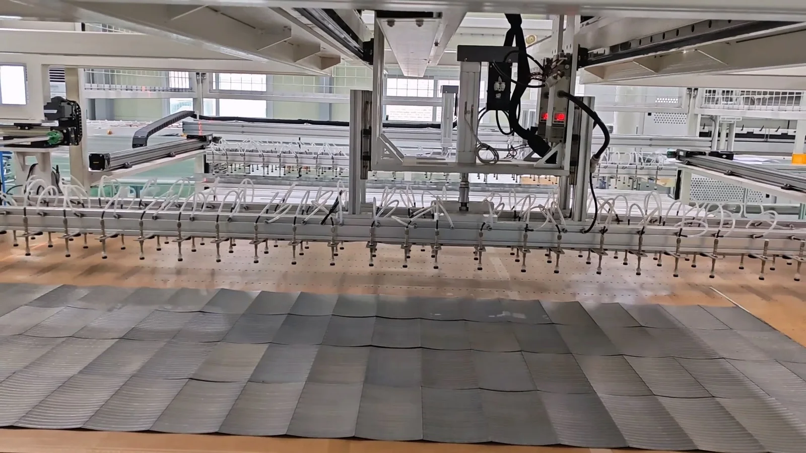 Ooitech layup and bussing machine laying up solar cell strings and soldering bus ribbons